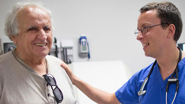 Physician speaking with patient in waiting room