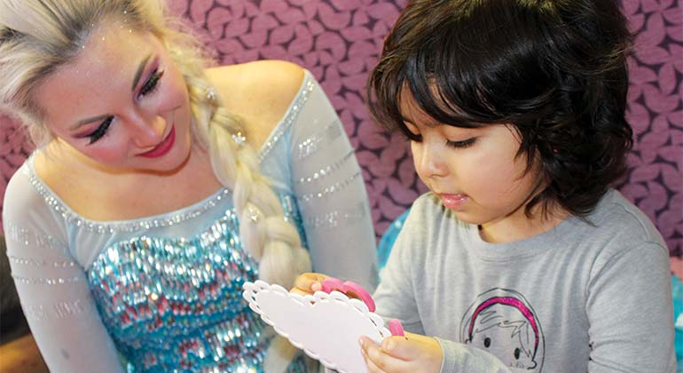 Young girl crafts a valentine with Princess Elsa