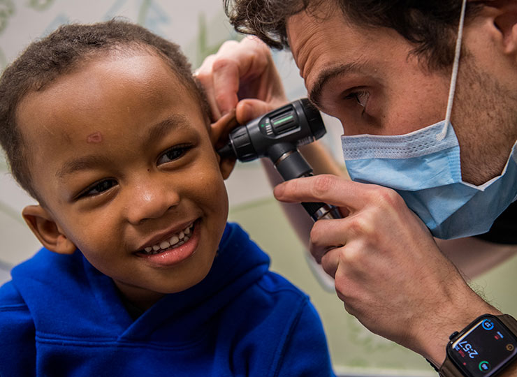 Photo of Image of doctor examining child