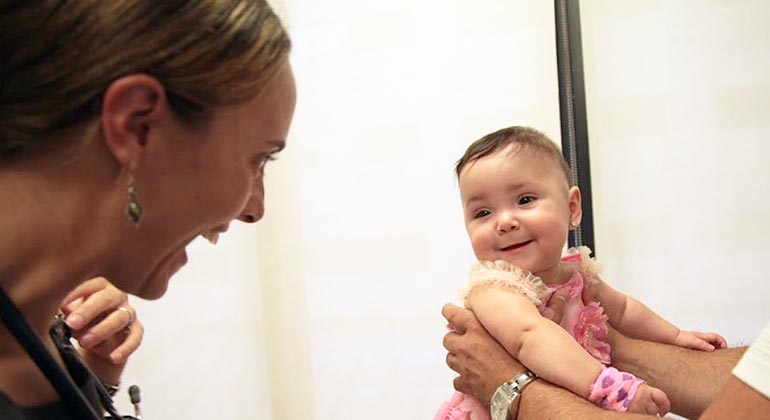 smiling baby during doctor exam