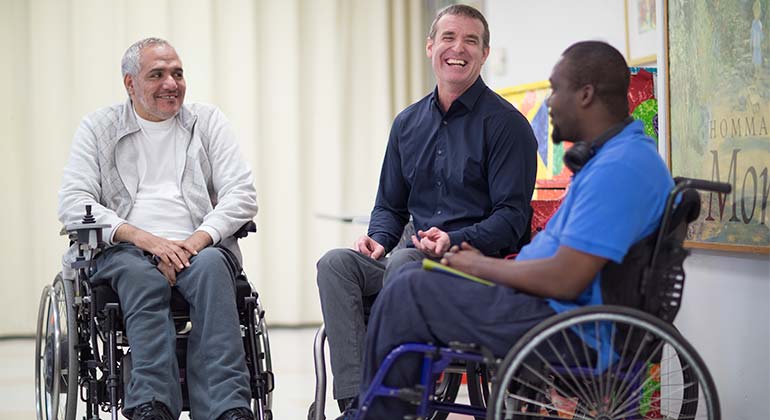 Three men in wheelchairs