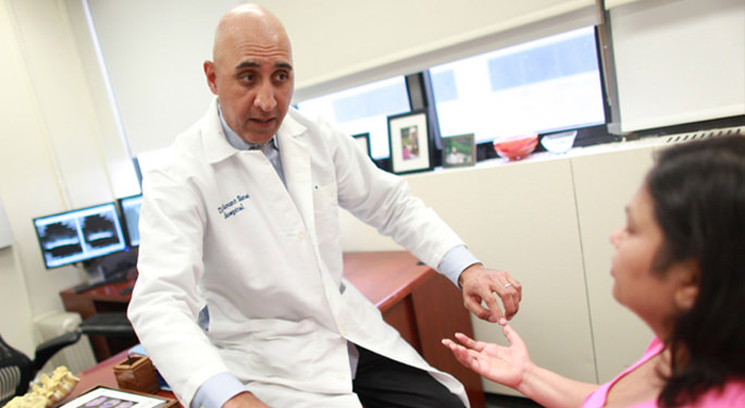 image of Dr. Choudhuri with patient in an office setting