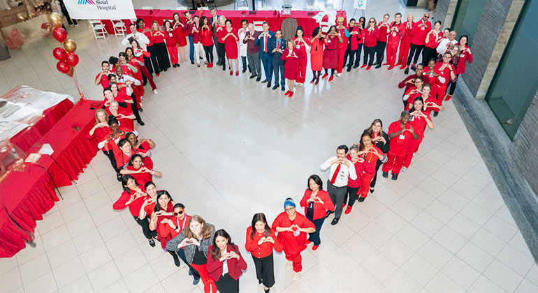 overhead view of team standing in the shape of a heart