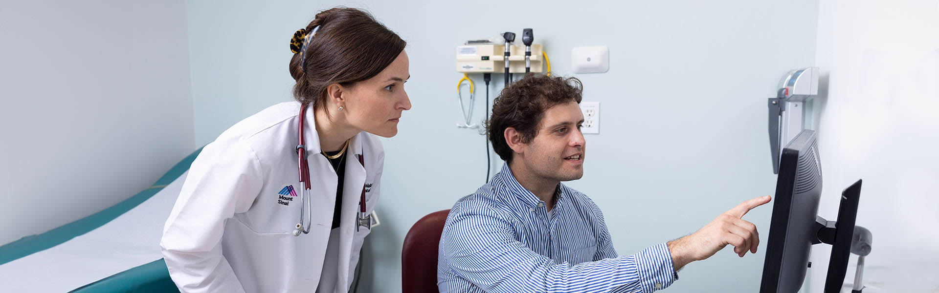 Image of doctors looking at computer screen