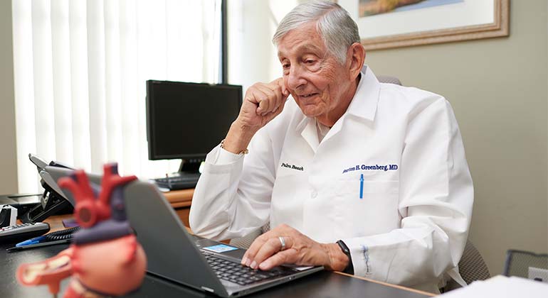 Image of doctor looking at laptop screen